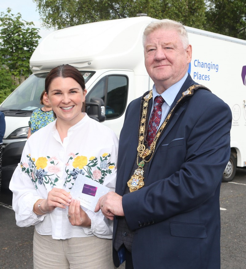 Sara Adair, Tourism Events Coordinator, receiving a Causeway Coast and Glens gift card from the Mayor of Causeway Coast and Glens Borough Council Councillor Steven Callaghan  – to be donated to Mae Murray Foundation.