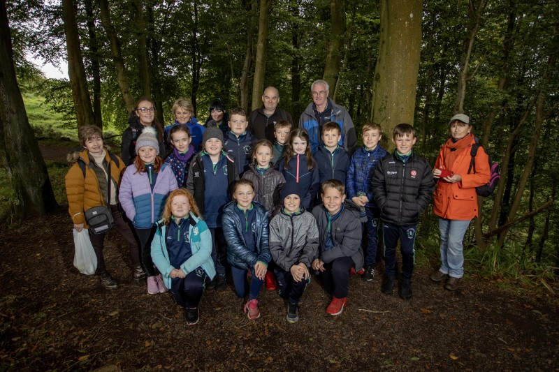 Staff and pupils from St Canice’s Primary School Feeny, with staff and students from Ulster University School of Education, facilitator Aubrey Beggs, President of Coleraine Rotary Michael Magee and Loretto Blackwood from Mountsandel Discovery and Heritage Group after a foraging tour of the woods.