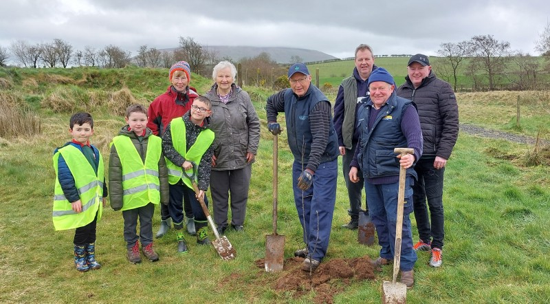 David Huey alongside pupils from St Olcan’s Primary School, Armoy WI and locals planting trees in Limepark in Armoy