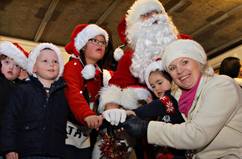 Mayor of Causeway Coast and Glens Borough Council, Councillor Michelle Knight-McQuillan, Santa and children from the Causeway Down Syndrome Group switch on Ballymoney's Christmas Lights.