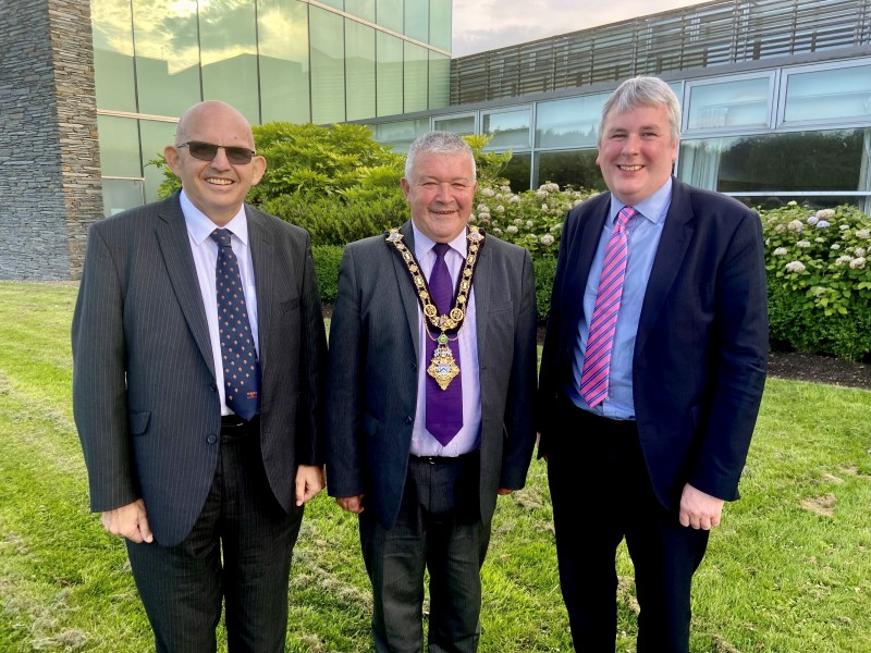Alderman John Finlay pictured with the new Mayor of Causeway Coast and Glens Borough Council Councillor Ivor Wallace as he receives his chain from outgoing Mayor, Councillor Richard Holmes, after the Annual Meeting held on June 7th 2022.