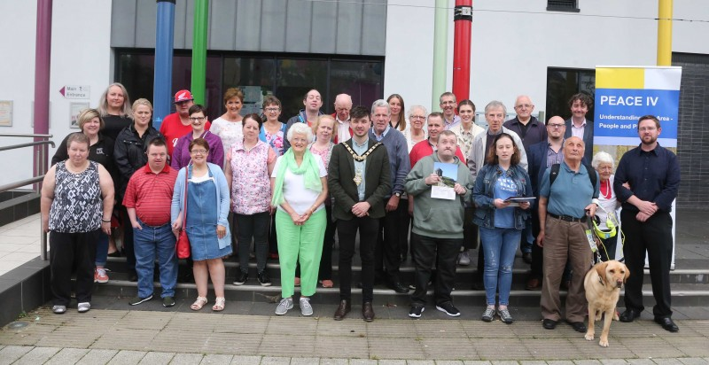 The Mayor of Causeway Coast and Glens Borough Council Councillor Sean Bateson pictured with Patricia Crossley, Vice Chair of the PEACE IV Partnership and participants and staff from Glenshane Care Association and RNIB at the launch of Causeway Coast and Glens Accessible Heritage Guide.