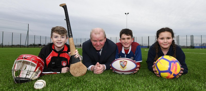 Councillor Tom McKeown pictured at the official opening of Ballymoney 3G pitch with Reece from Our Lady of Lourdes, Oliver from Dalriada and Jayne from Ballymoney High School.