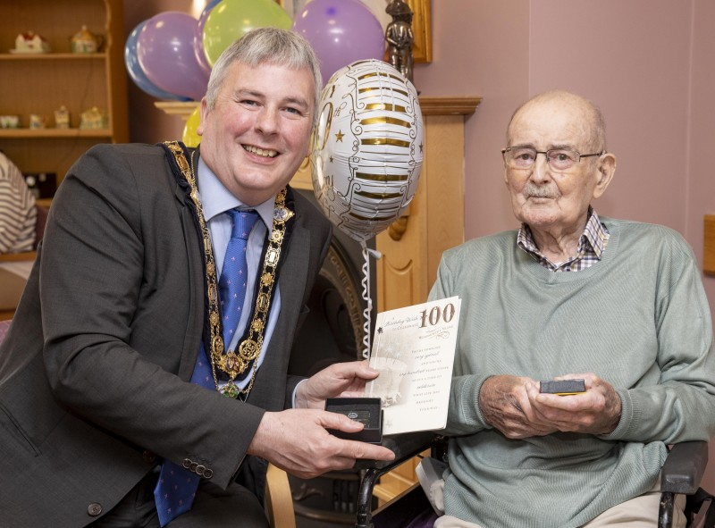 Bertie Watson receives his special Platinum Jubilee gift from the Mayor of Causeway Coast and Glens Borough Council, Councillor Richard Holmes, at his residence at Brookmount Nursing Home, Coleraine.