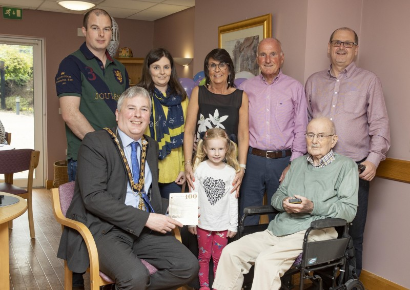 The Mayor of Causeway Coast and Glens Borough Council, Cllr Richard Holmes, (front-left) was privileged to present centenarian Bertie Watson (front-right) with a special Platinum Jubilee gift. Pictured are Bertie’s family (l-r): Colin and Jenny Devine (granddaughter and husband); Lorna and Keith Elliott (daughter and son-in-law); Alan Watson (son); and young Sophie Devine (great-granddaughter).
