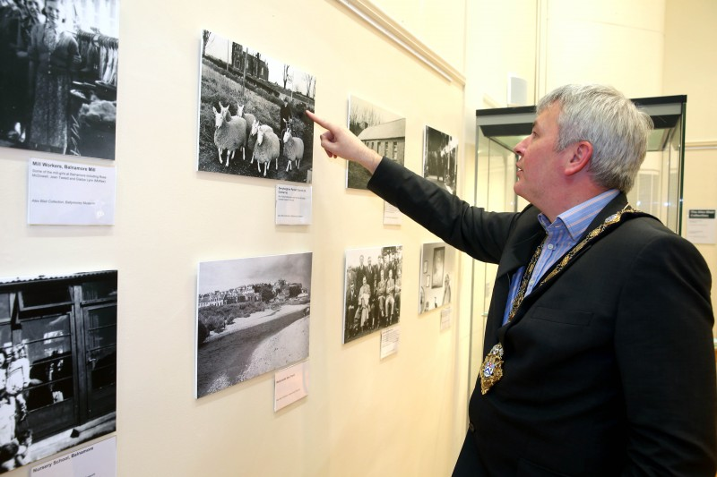 The Mayor of Causeway Coast and Glens Borough Council, Councillor Richard Holmes, views a photograph of Rev Robert McIlmoyle with his sheep in Dervock which is on display at Ballymoney Museum as part of an exhibition showcasing the personal collection of Alex Blair