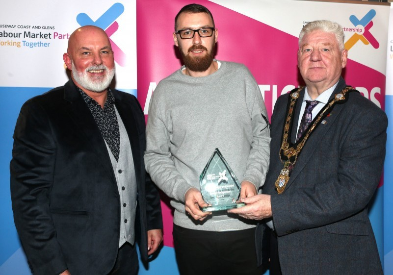 Mayor of Causeway Coast and Glens, Councillor Steven Callaghan alongside Labour Market Partnership Manager, Marc McGerty presenting Ryan Buckley with a Special Recognition Award.