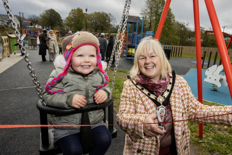 Deputy Mayor of Causeway Coast and Glens, Councillor Margaret Anne McKillop cuts the ribbon to officially open the refurbished Armoy Playpark with Maddie McCooke from Armoy.