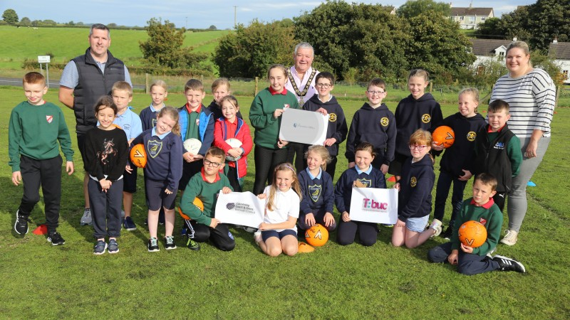 The Mayor of Causeway Coast and Glens Borough Council, Councillor Ivor Wallace and Good Relations Officer Gerard McIlroy pictured with pupils from St Olcan’s Primary School, Armoy and Straidbilly Primary School who took part in the joint schools event.