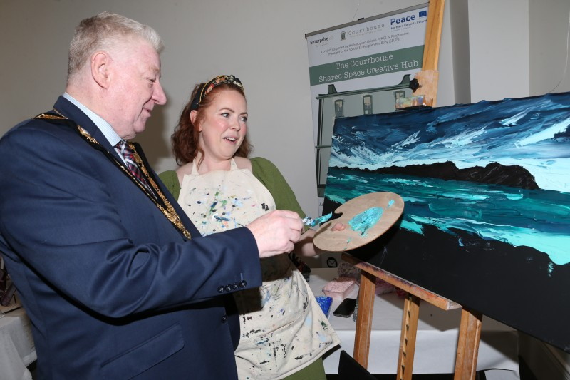 The Mayor, Councillor Steven Callaghan tries his hand at painting with Maud McArthur from The Designerie