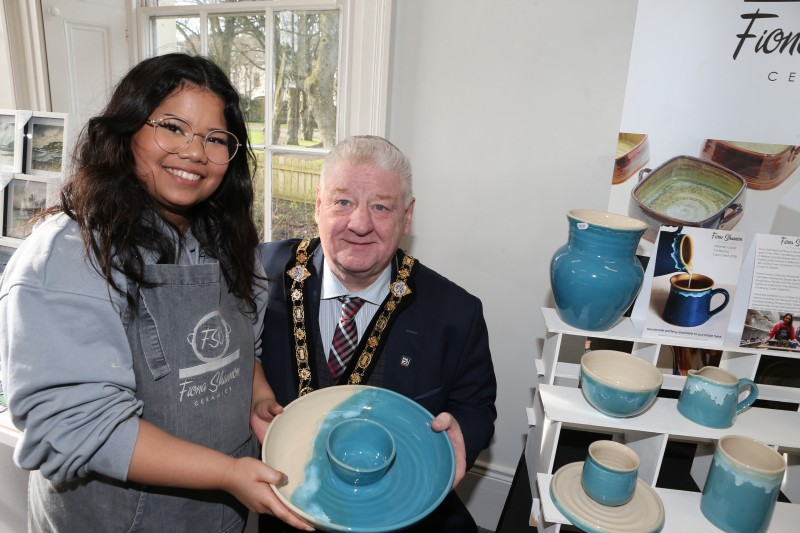 Lucy Hutchinson of Fiona Shannon Ceramics shows some of her wares to the Mayor of Causeway Coast and Glens, Councillor Steven Callaghan.