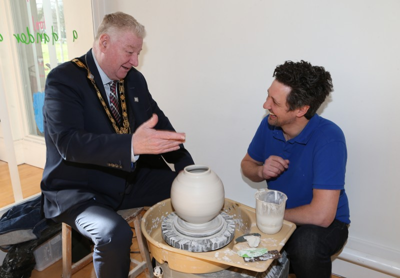 Mayor of Causeway Coast and Glens, Councillor Steven Callaghan receives a lesson in ceramic making from artist Adam Frew.