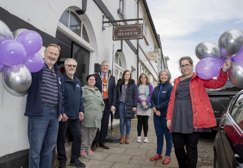 The Mayor of Causeway Coast and Glens Borough Council Councillor Richard Holmes mark the reopening of Ballycastle Museum with Friends of Ballycastle Museum volunteers and Council’s Museum Services Development Manager Sarah Carson (right).