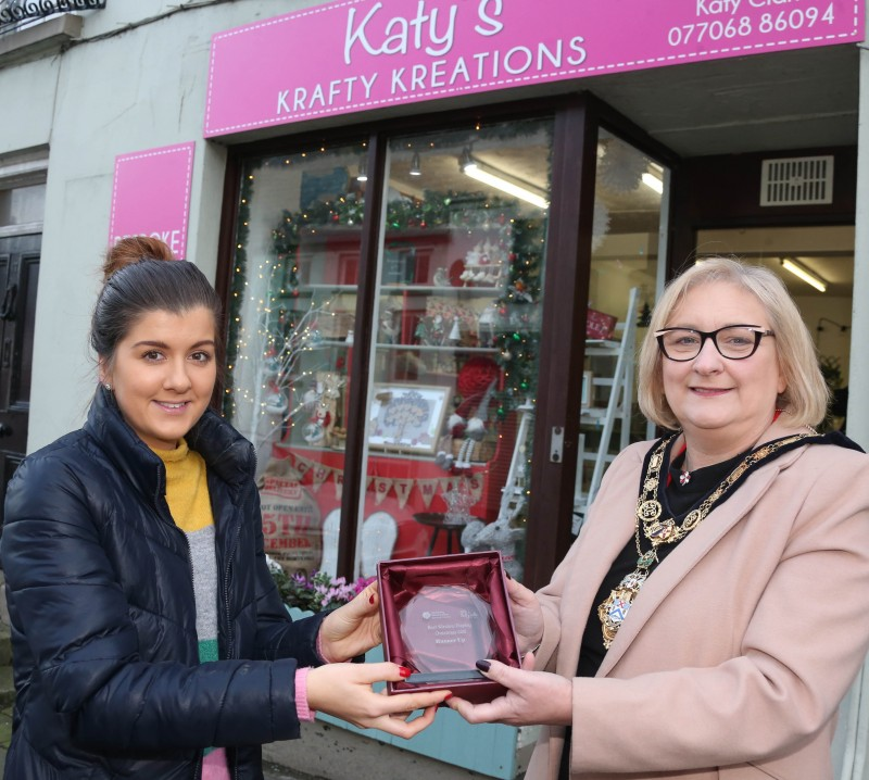 Katy Clark from Katy’s Krafty Kreations, runner-up of the Christmas window competition in Ballycastle receives her award from the Mayor of Causeway Coast and Glens Borough Council Councillor Brenda Chivers.