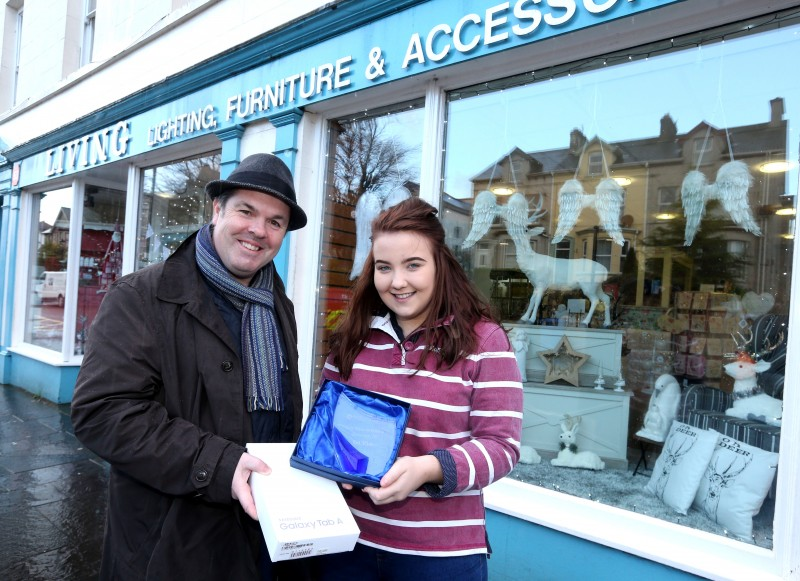 Grace Wilkinson accepts the prize on behalf of Patricia McNamara after her shop, Living Lighting, Furniture and Accessories was selected as the winner of the Christmas Window Competition in Ballycastle, organised by Causeway Coast and Glens Borough Council’s Town Management team. Also included is Causeway Coast and Glens Borough Council Officer Shaun Kennedy.