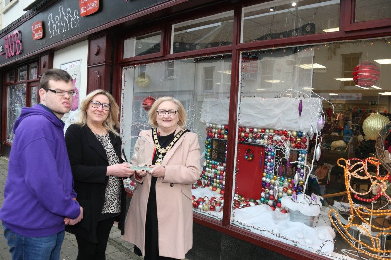 Jane Cole and Colm McIlver from Can Can Bazaar, runner-up of the Christmas window competition in Ballymoney receive their award from the Mayor of Causeway Coast and Glens Borough Council Councillor Brenda Chivers.