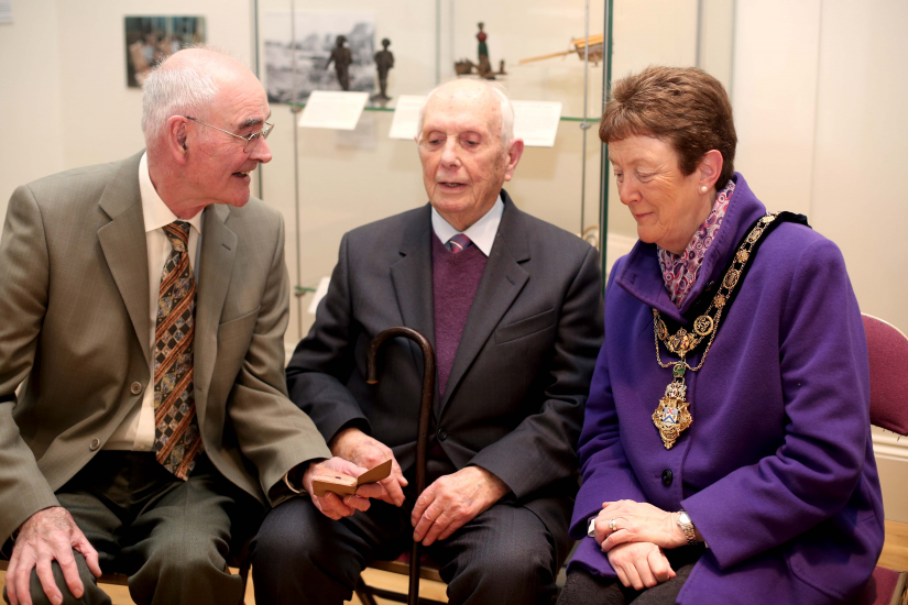 Edwin RL Chambers’ son Laurence holds the tiny pocket bibles as Ernest Crawford and the Mayor of Causeway Coast and Glens Borough Council, Councillor Joan Baird OBE, look on.