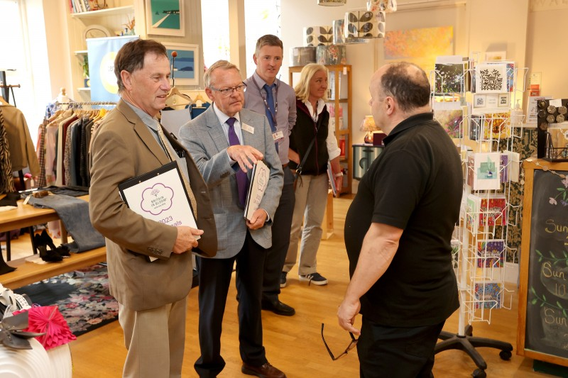 Noel Davoren, Council’s Estates Manager joins Britian in Bloom judges Rae Beckwith and Roger Burnett as they meet Causeway Speciality Market stall holder Graham Watts of Causeway Coffee. Graham is also a resident in town centre business Stone Row Artisans.