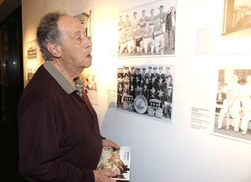 Nelson McGonagle peering at some of the photographs from his new book currently on display in the Roe Valley Arts & Cultural Centre.