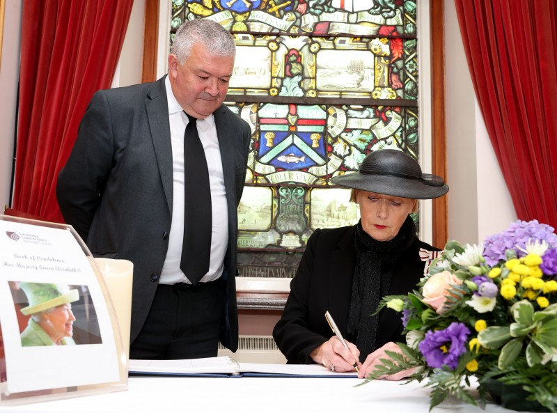 The Lord-Lieutenant of County Londonderry, Mrs Alison Millar, signs the book of condolence in Coleraine Town Hall, along with the Mayor of Causeway Coast and Glens Borough Council, Councillor Ivor Wallace.