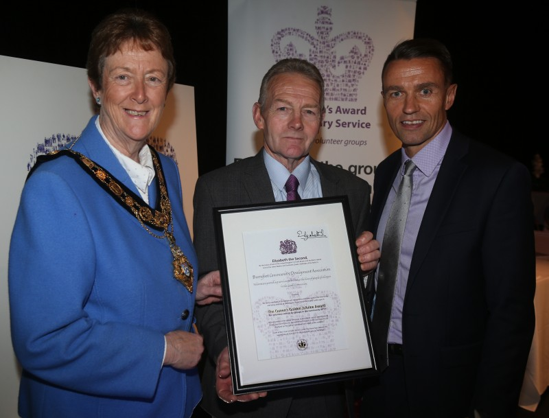 Boyd Douglas, Chairman of Burnfoot Community Association, displays the certificate signed by HM The Queen with the Mayor of Causeway Coast and Glens Borough Council Councillor Joan Baird OBE and Chief Executive David Jackson.