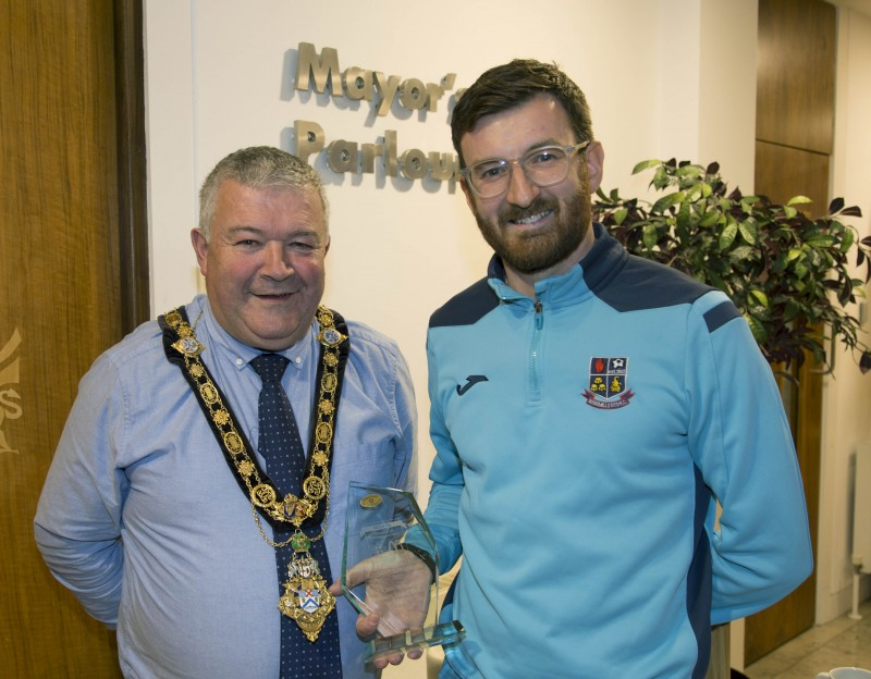 The Mayor of Causeway Coast and Glens Borough Council, Councillor Ivor Wallace, pictured with North West Regional Grassroots Coach of the Year Chris McKendry from Bushmills United Youths.