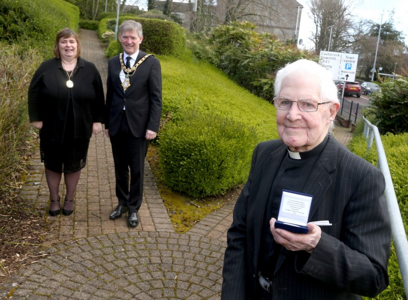 Canon Robert Wilkinson, who celebrated his 100th birthday on March 24th 2021, pictured with his commemorative centenary coin received from the Mayor of Causeway Coast and Glens Borough Council Alderman Mark Fielding and Mayoress Mrs Phyllis Fielding.