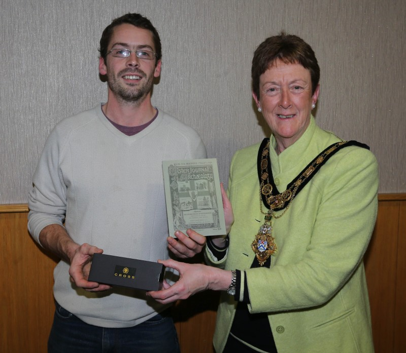 Pictured accepting a gift from the Mayor of Causeway Coast and Glens Borough Council, Councillor Joan Baird OBE, is Fintan Mc Carry from Carey Historical Society.