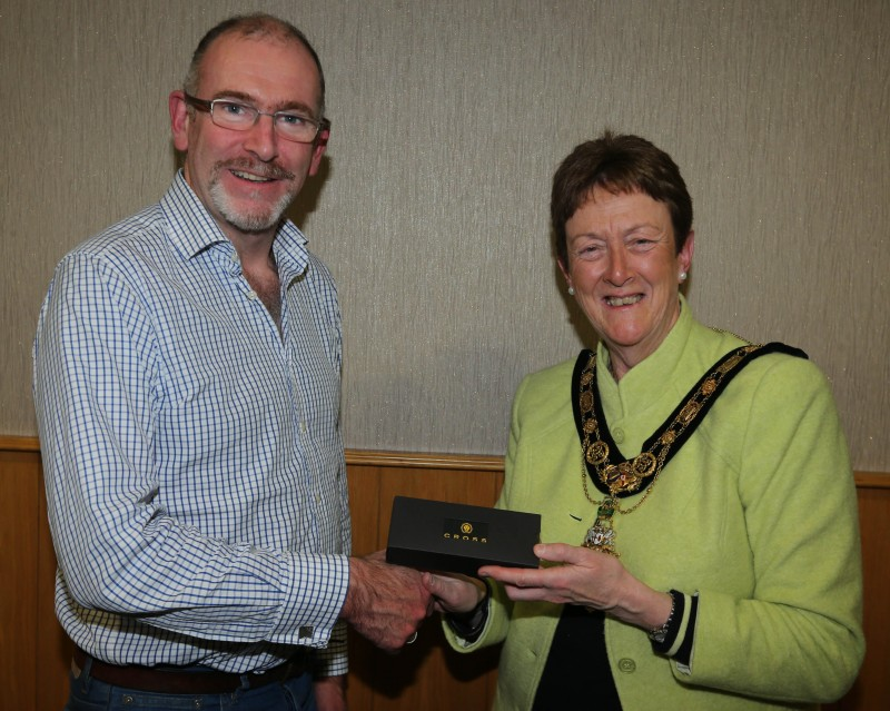 Pictured accepting a gift from the Mayor of Causeway Coast and Glens Borough Council, Councillor Joan Baird OBE, is Aidan Mc Michael from Carey Historical Society.
