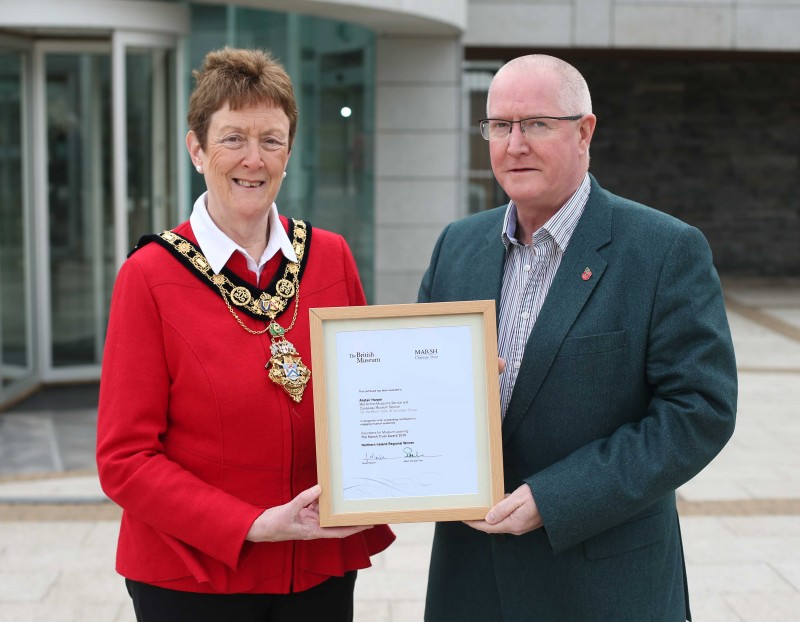 The Mayor of Causeway Coast and Glens Borough Council Councillor Joan Baird OBE presents Alastair Harper with his Marsh Award certificate from the British Museum.