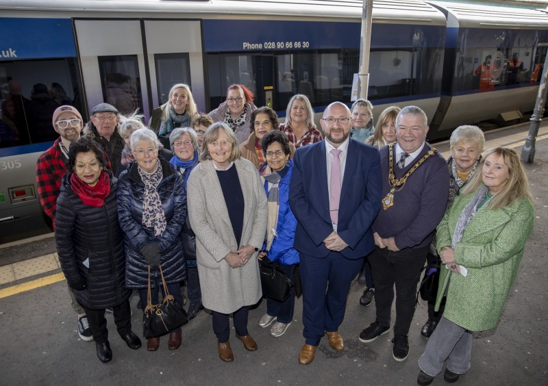 The Mayor of Causeway Coast and Glens Borough Council, Councillor Ivor Wallace, pictured with representatives from Translink and the Causeway Loneliness Network with some of those who took part in the pilot Chatty Carriages initiative.