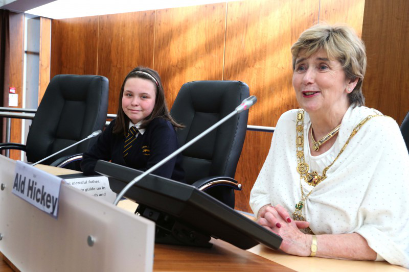 Mayor with Amy McLean from Limavady Central Primary School takes her seat in the Council Chamber alongside the Mayor of Causeway Coast and Glens Borough Council, Alderman Maura Hickey.