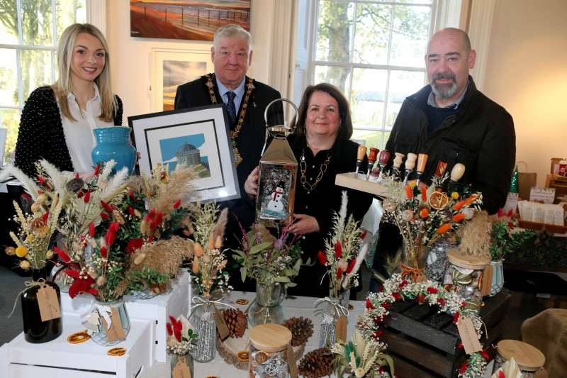 Amy Donaghey Arts Marketing and Engagement Officer, The Mayor of Causeway Coast and Glens, Councillor Steven Callaghan, Desima Connolly Council’s Arts Services Manager, Pat Brown from Bare Leaf Makers, the group are standing beside Urban Bloom Creative’s stall at the Flowerfield Christmas Craft Market.
