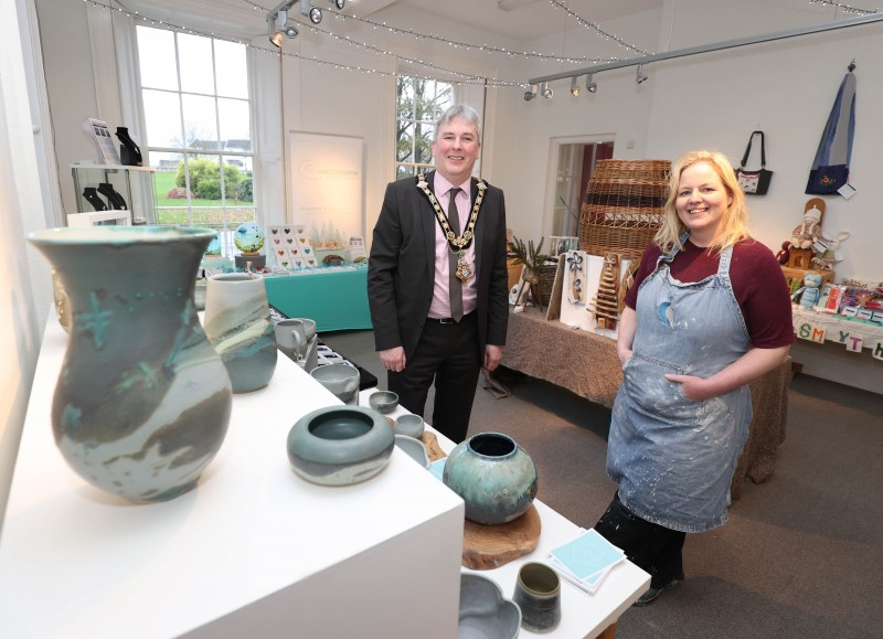 The Mayor of Causeway Coast and Glens Borough Council, Councillor Richard Holmes learns more about the work of ceramic artist Lorna Noble at the Christmas Craft Market in Flowerfield Arts Centre.