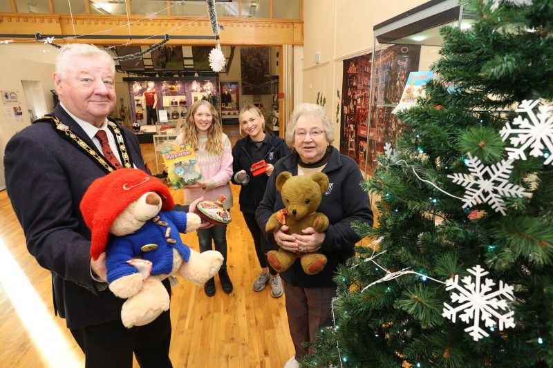 Mayor of Causeway Coast and Glens, Councillor Steven Callaghan alongside Museum Officer Jamie Austin, Lynda Bartlett and Kathleen Walker holding vintage toys selected for the Treasured Toy Exhibition.