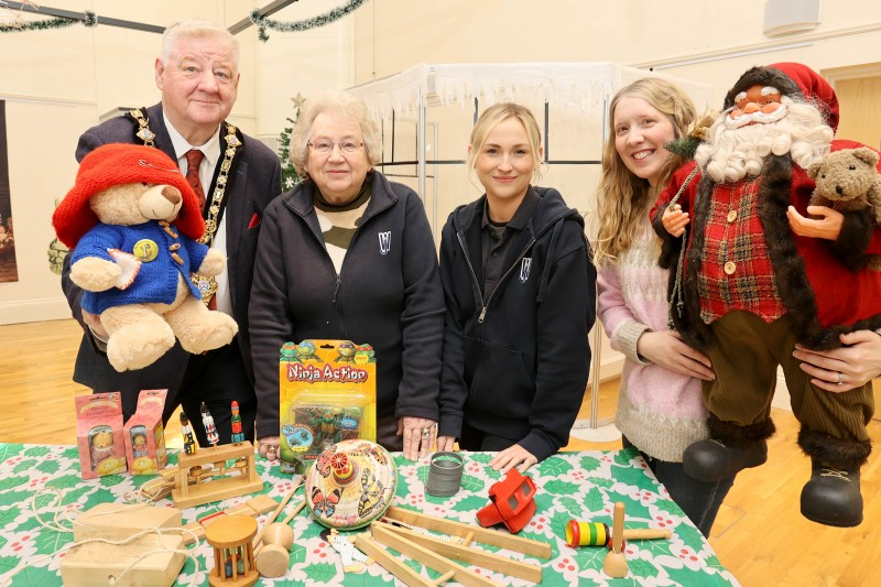 Mayor of Causeway Coast and Glens, Councillor Steven Callaghan alongside Kathleen Walker, Lynda Bartlett and Museum Officer Jamie Austin with several of the toys from days gone by which are featured within the exhibition