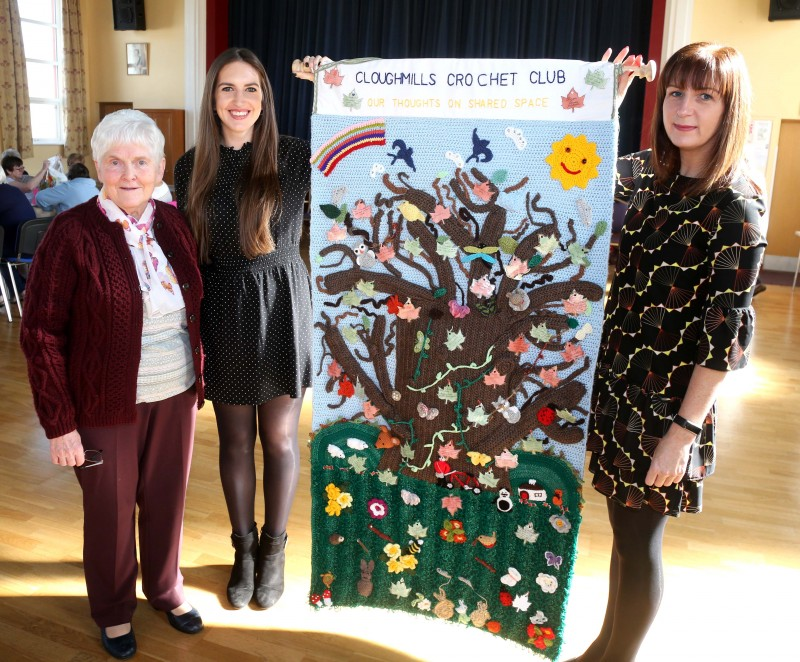 Cloughmills Crochet Group member Mae Aitcheson pictured with Amy McWilliams, and Patricia Harkin from Causeway Coast and Glens Borough Council’s Good Relations Team along with the piece of art created by the group to depict shared space.