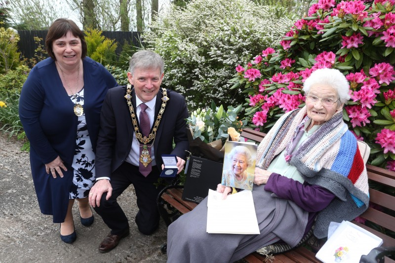 Margaret Mitchel, who celebrated her 100th birthday on 26th April 2021, receives her commemorative coin from the Mayor of Causeway Coast and Glens Borough Council Alderman Mark Fielding and Mayoress Mrs Phyllis Fielding.