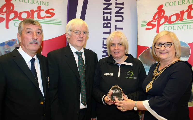 Lisa Christie from Sika Gymnastics Club, winner of the Merit Award at Coleraine Sports Award for her services to the club, accepts her award from the Mayor of Causeway Coast and Glens Borough Council  Councillor Brenda Chivers with John Church, Chair Coleraine Sports Council and Robert McVeigh from Northern Ireland Commonwealth Games Council.