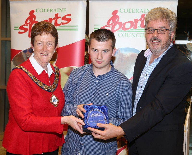 Joel McClelland, a member of the Coleraine Cougars Special Olympics Basketball Club receives his award for Sportsperson with a Disability from the Mayor of Causeway Coast and Glens Borough Council Councillor Joan Baird OBE and Grant Cameron, BBC Sport Northern Ireland.