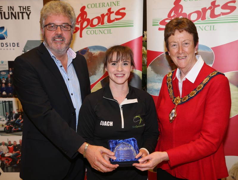 Coach of the Year Mary Robinson from Sika Gymnastics Club receives her award from the Mayor of Causeway Coast and Glens Borough Council Councillor Joan Baird OBE and Grant Cameron, BBC Sport Northern Ireland.