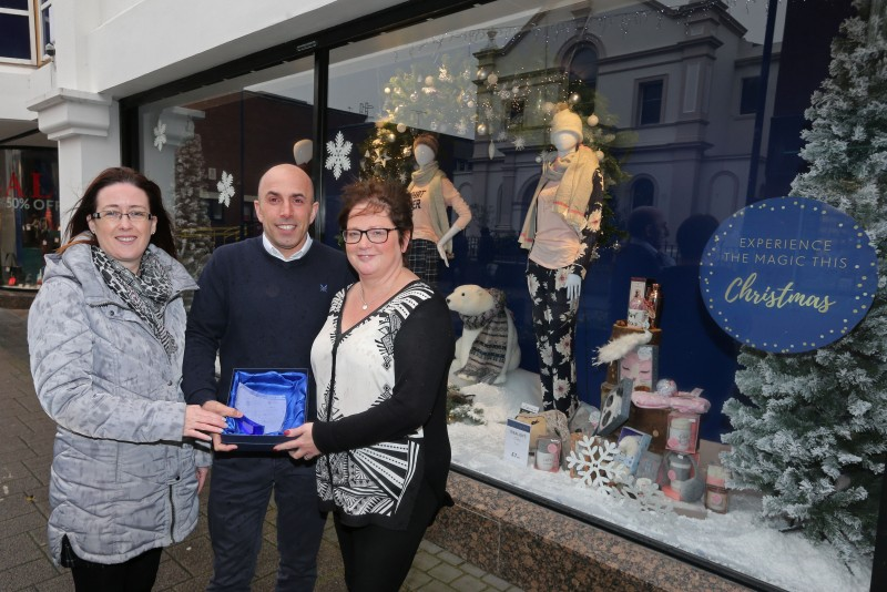 Simon Colquhoun & Jayne Booth from Moores receive their prize after the shop was selected as the winner of the Christmas Window Competition in Coleraine, organised by Causeway Coast and Glens Borough Council’s Town Management team. Also included is Causeway Coast and Glens Borough Council Officer Catrina McNeill.