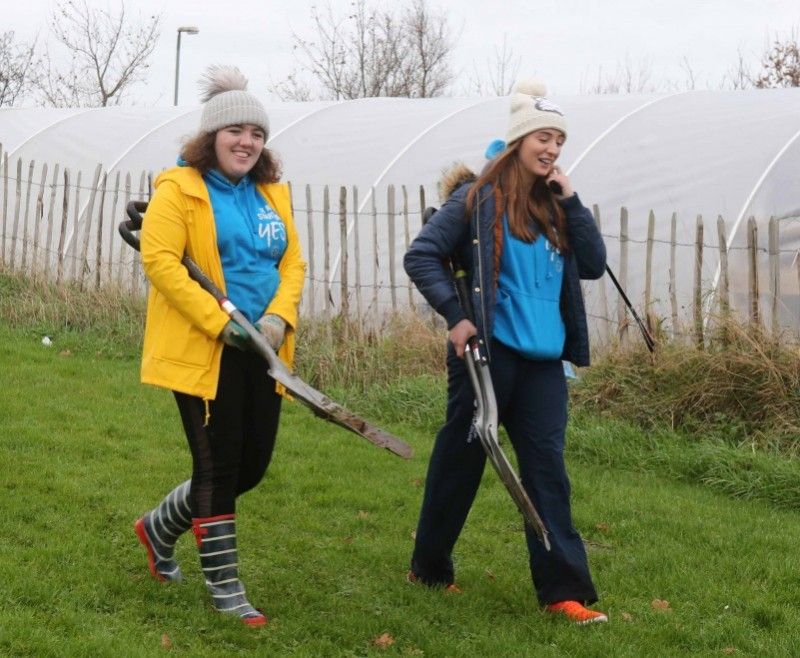 Sorcha McGrellis and Gemma Quigg get ready to plant some trees at the Cornfield site in Coleraine.