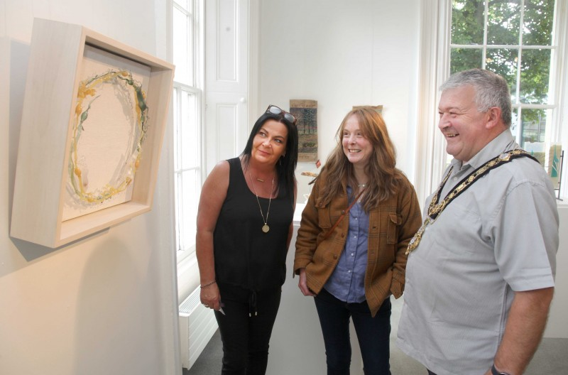 Admiring the work of Andrea Spencer, glass artist are Shona Kerr, Flowerfield Arts Centre Duty Officer, artist Andrea Spencer and the Mayor of Causeway Coast and Glens Borough Council, Councillor Ivor Wallace.
