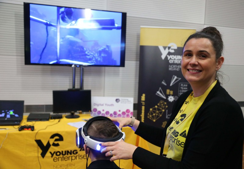 Bronagh McCauley from Young Enterprise who are running a Digital Youth initiative on behalf of Causeway Coast and Glens Borough Council helps a young pupil try out a VR headset at the ‘Don’t Worry Be #appy’ Internet Resilience and Safety’ conference organised by Causeway Coast and Glens Policing and Community Safety Partnership.