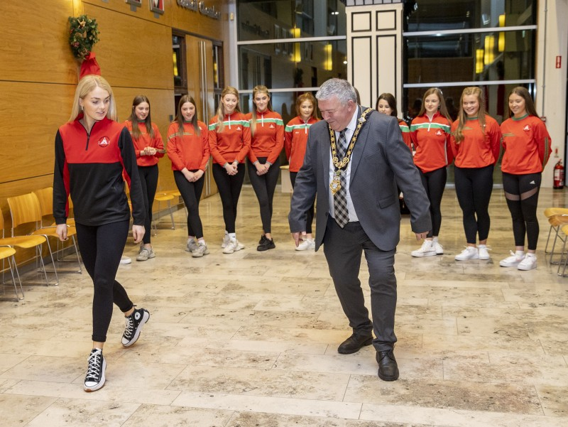 The Mayor of Causeway Coast and Glens Borough Council, Councillor Ivor Wallace, is shown some steps during the reception for Loughgiel School of Irish Dance.