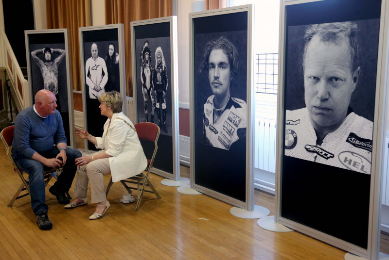 The Mayor of Causeway Coast and Glens Borough Council, Alderman Maura Hickey, chats with photographer Stephen Davison, who took the pictures featured in the BBC Northern Ireland Road Racing People exhibition.