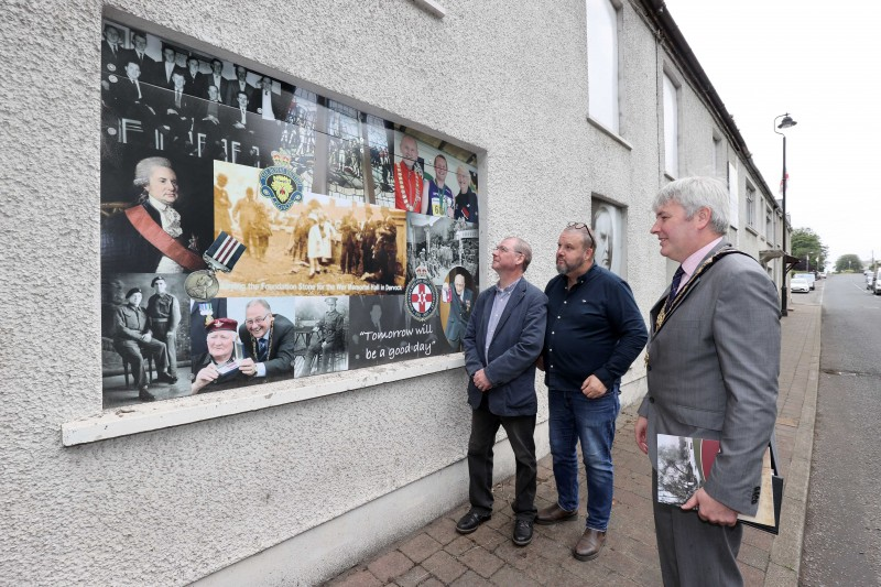The Mayor of Causeway Coast and Glens Borough Council Councillor Richard Holmes views the art panels along the Castlecatt Road during his recent visit to Dervock with Keith Beattie, author & local historian and Frankie Cunningham, Chair of Dervock & District Community Association.