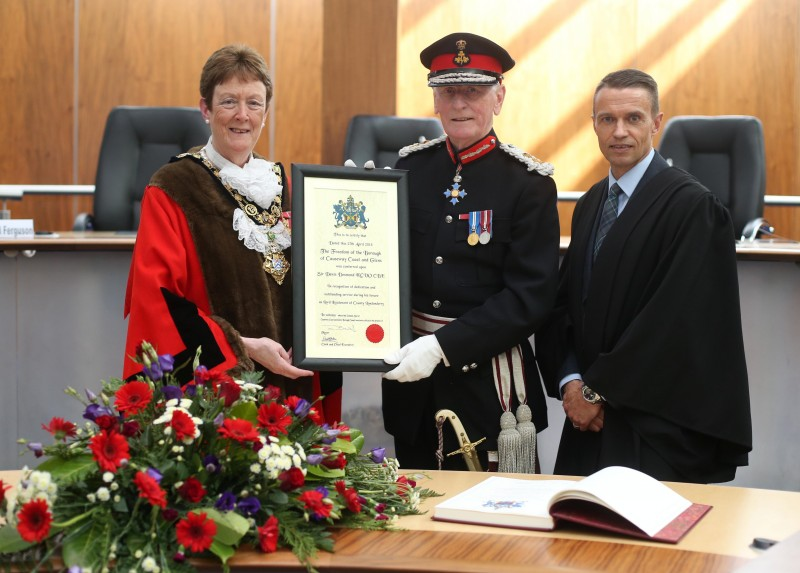 Sir Denis Desmond KCVO CBE, Lord Lieutenant of County Londonderry accepts his Freedom certificate from the Mayor of Causeway Coast and Glens Borough Councillor Joan Baird OBE and Council Chief Executive David Jackson.