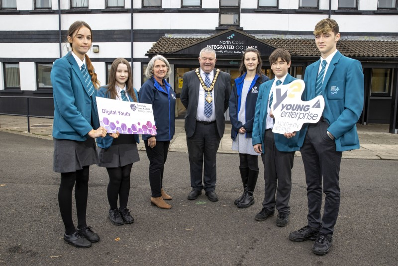 The Mayor of Causeway Coast and Glens Borough Council, Councillor Ivor Wallace, pictured at the launch of the Digital Schools programme with pupils from North Coast Integrated College in Coleraine and Sharon Barrett and Jane Hanna, Area Managers with entrepreneurship charity Young Enterprise.